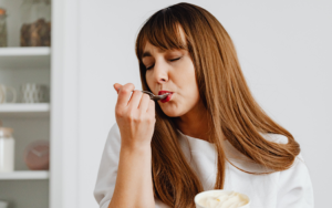 Woman in white shirt tasting ice cream - Leveraging Taste Through Food & Beverage Marketing blog