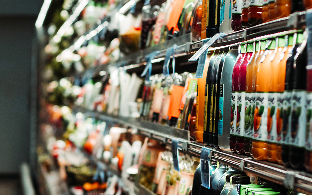 side angle of a refrigerated aisle of a grocery store - Making the Jump to Larger Retailers: What Food and Beverage Brands Need to Know