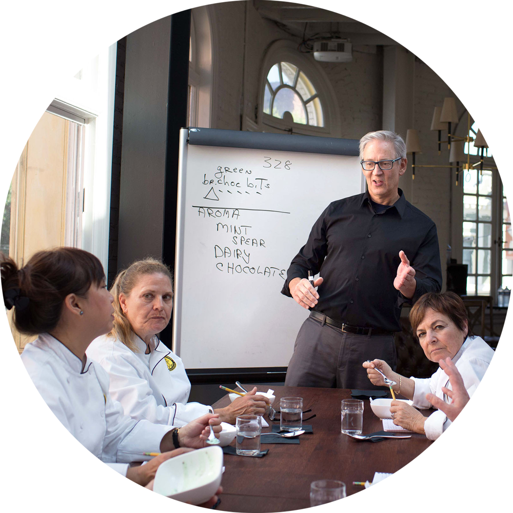 Chefs at a table with a whiteboard